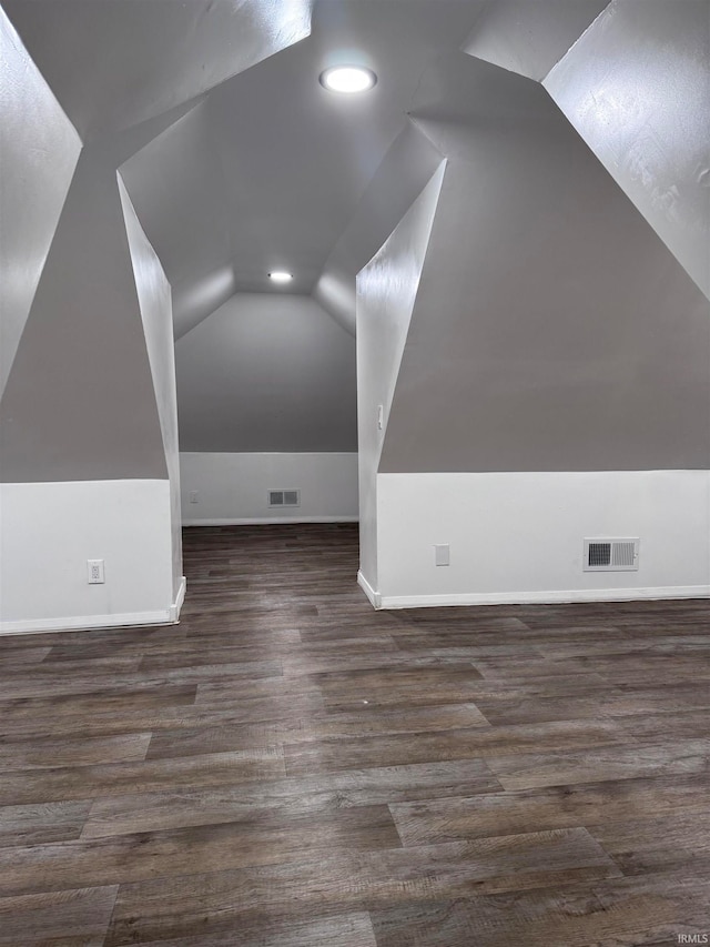 bonus room featuring lofted ceiling and dark wood-type flooring