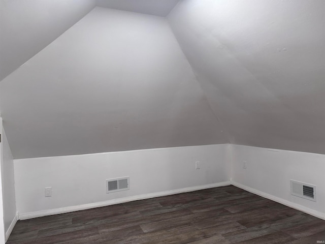 additional living space featuring dark hardwood / wood-style flooring and vaulted ceiling