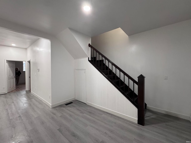 stairs with wood-type flooring