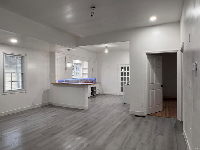 unfurnished living room featuring wood-type flooring