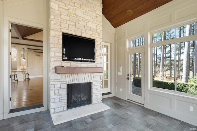 unfurnished living room featuring a fireplace, high vaulted ceiling, wooden ceiling, and dark hardwood / wood-style floors