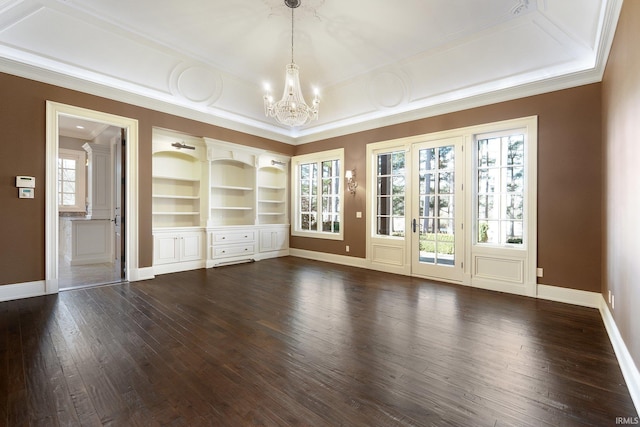 unfurnished living room with plenty of natural light, dark hardwood / wood-style flooring, and ornamental molding