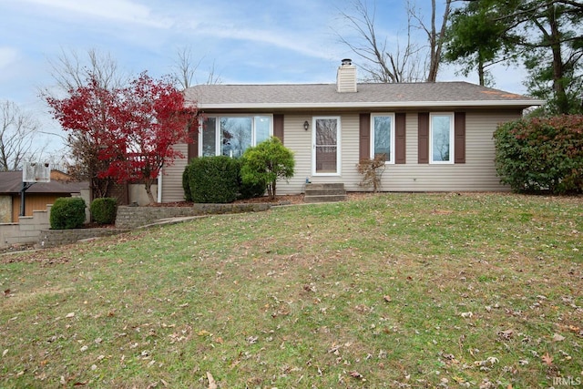 ranch-style home featuring a front lawn