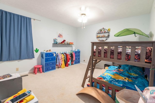 bedroom featuring a textured ceiling and carpet floors