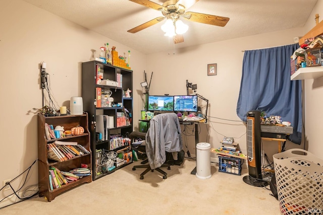 carpeted office with ceiling fan and a textured ceiling