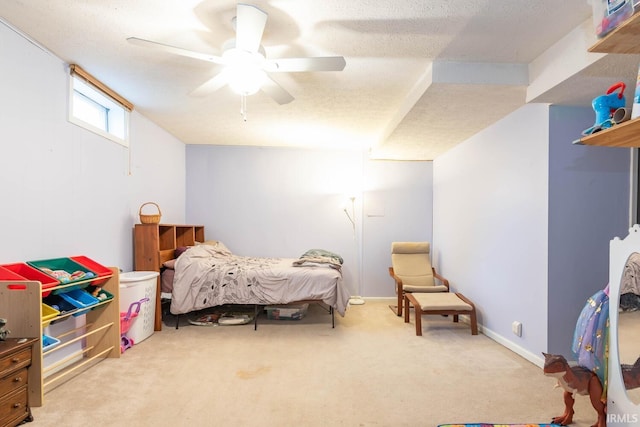 bedroom with ceiling fan, a textured ceiling, and light carpet