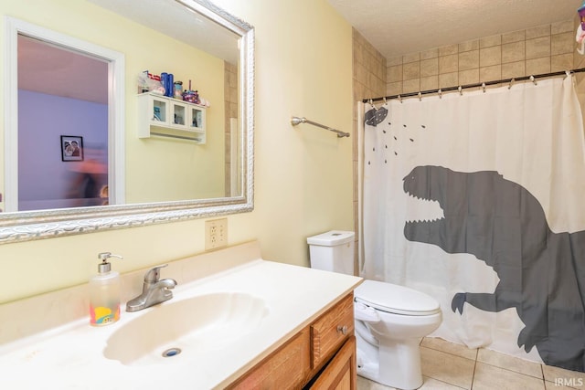 bathroom featuring toilet, a textured ceiling, walk in shower, tile patterned flooring, and vanity