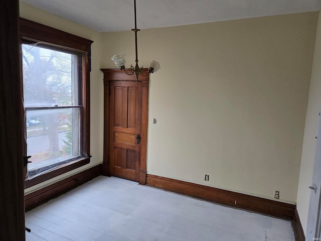 spare room with a chandelier