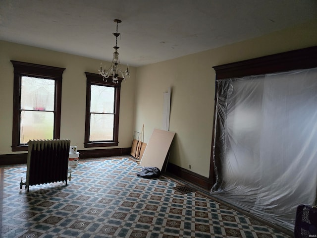 sitting room with a chandelier and radiator heating unit