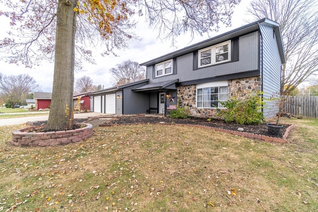 view of front of home with a front lawn and a garage