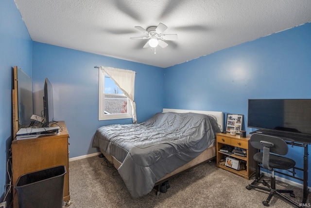 bedroom featuring ceiling fan, carpet floors, and a textured ceiling