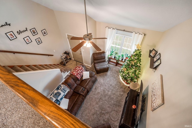 living room with ceiling fan, carpet floors, and vaulted ceiling