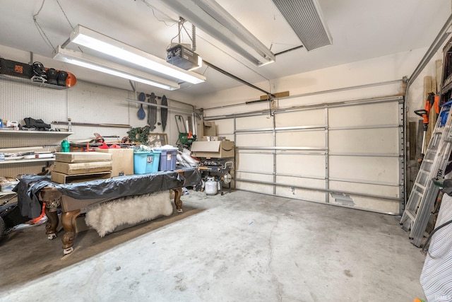 garage with a workshop area and a garage door opener