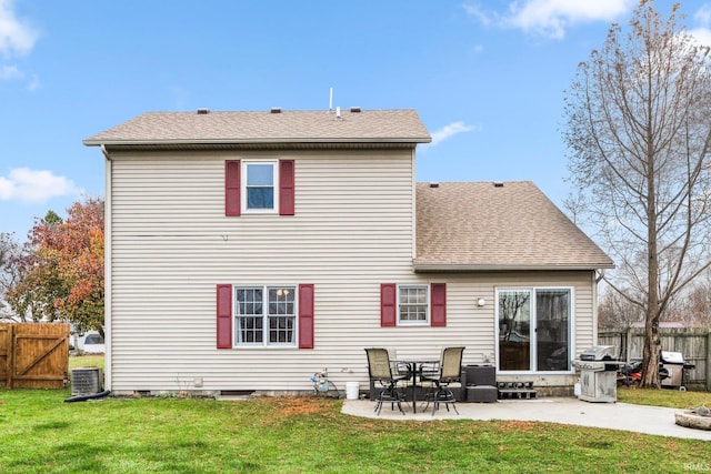 rear view of property featuring central AC, a patio area, and a lawn