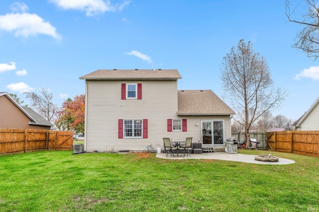 rear view of house featuring cooling unit, a patio area, and a yard