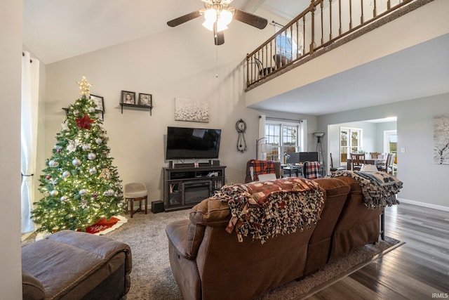 living room featuring ceiling fan, high vaulted ceiling, and dark wood-type flooring