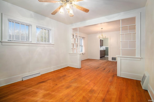 unfurnished room featuring hardwood / wood-style floors and ceiling fan with notable chandelier