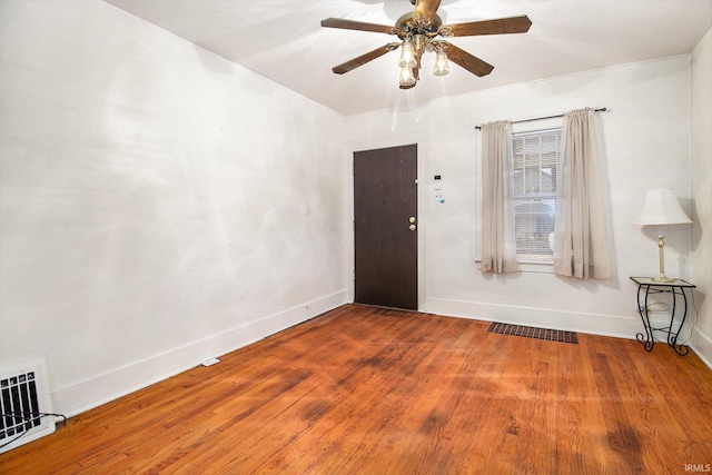 empty room with hardwood / wood-style floors and ceiling fan