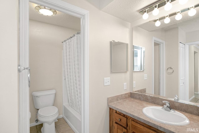 full bathroom featuring tile patterned floors, a textured ceiling, toilet, shower / tub combo with curtain, and vanity