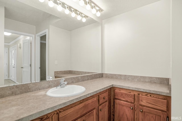 bathroom with a textured ceiling and vanity