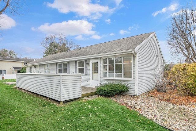 rear view of property featuring a yard