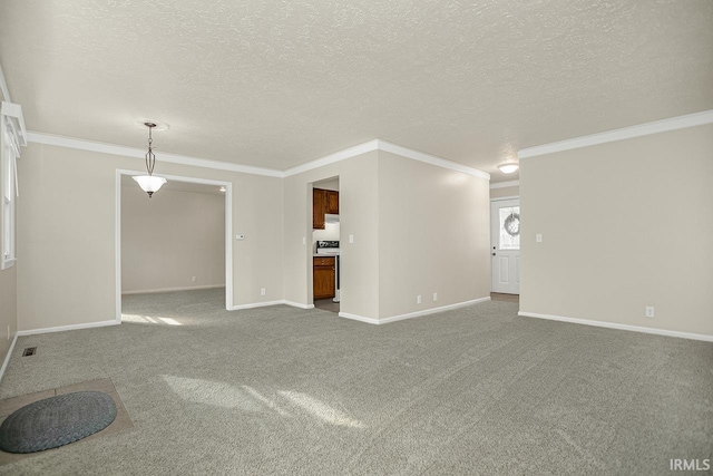 unfurnished living room featuring carpet flooring, a textured ceiling, and ornamental molding