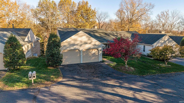 ranch-style house with a front yard and a garage