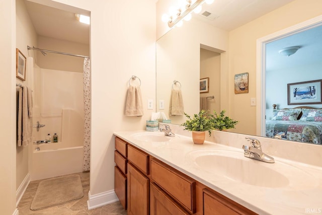 bathroom with shower / tub combo with curtain, vanity, and tile patterned flooring