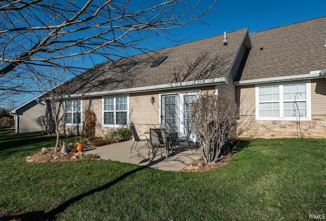 back of property featuring a lawn and a patio area