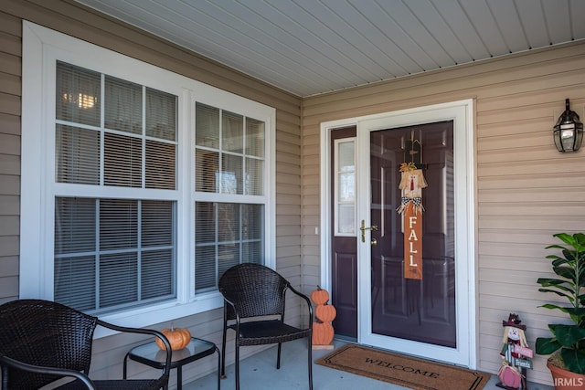 view of exterior entry with covered porch