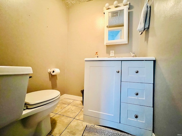 bathroom with tile patterned floors, vanity, and toilet