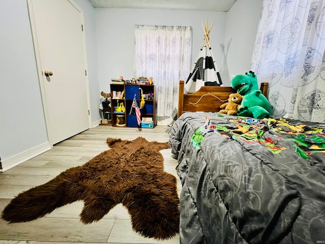 bedroom with hardwood / wood-style flooring