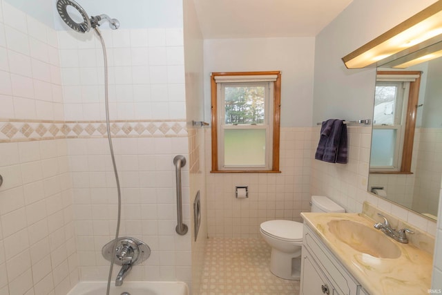 full bathroom with tiled shower / bath combo, tile walls, and a healthy amount of sunlight