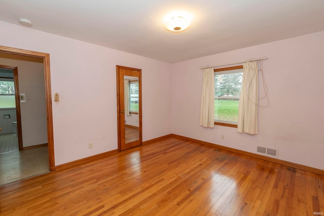 unfurnished room with light hardwood / wood-style flooring