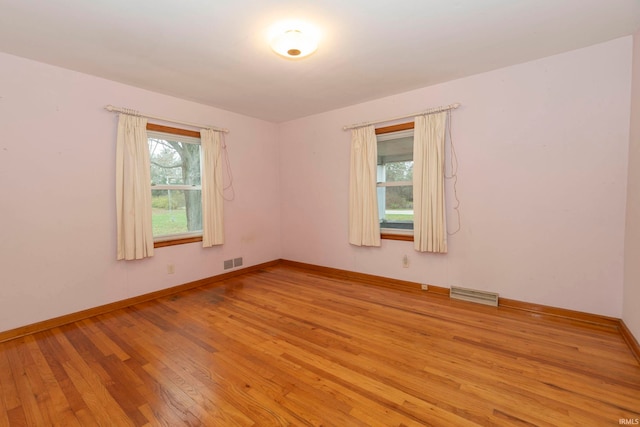 spare room with light hardwood / wood-style floors