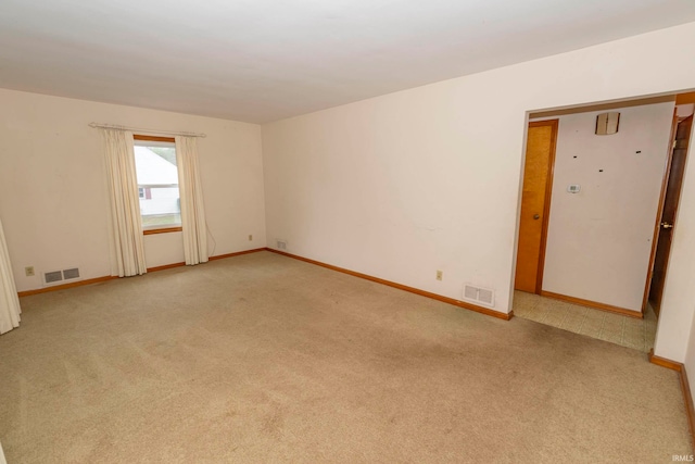 unfurnished room featuring light colored carpet