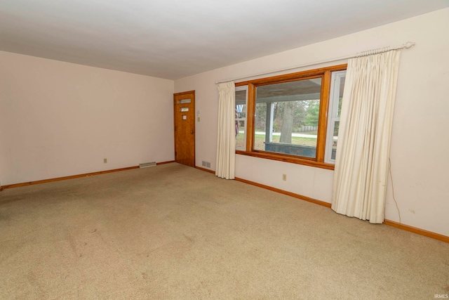 spare room with light carpet