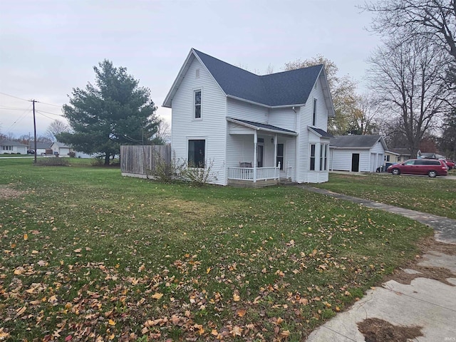 view of home's exterior with covered porch and a yard