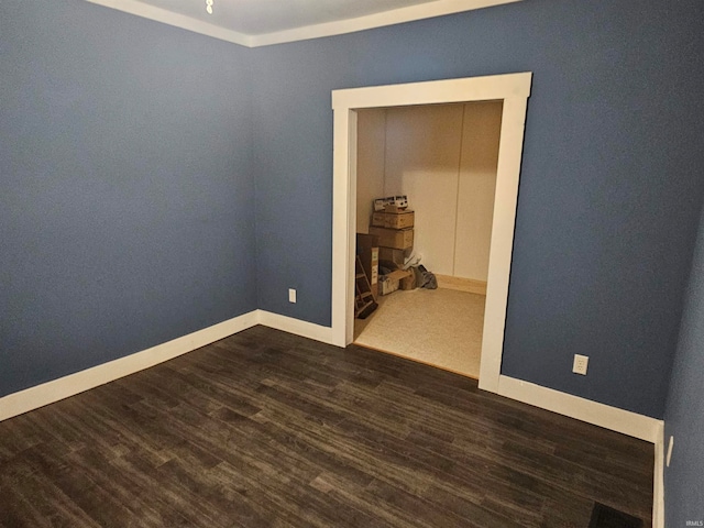 spare room featuring dark hardwood / wood-style flooring