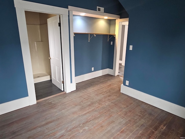 unfurnished bedroom with wood-type flooring and a closet