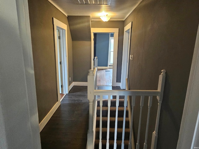 hallway with dark hardwood / wood-style flooring and ornamental molding