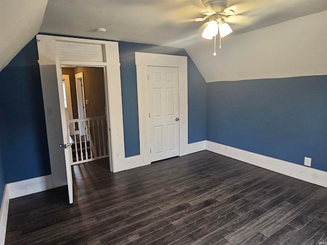 bonus room with vaulted ceiling, ceiling fan, and dark wood-type flooring