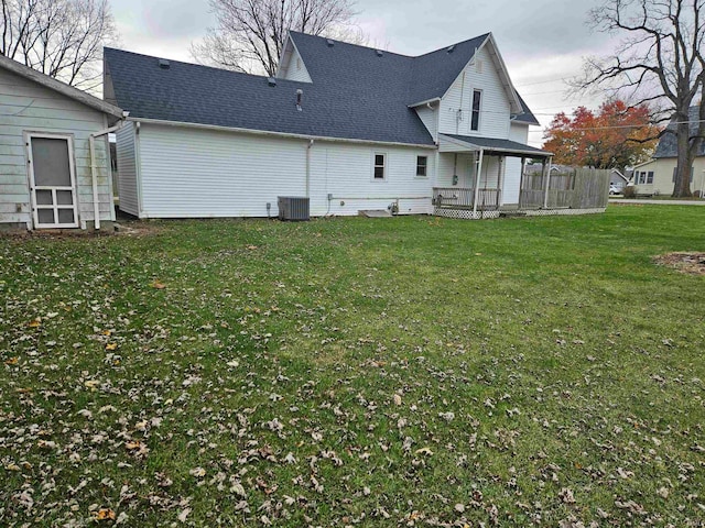 back of property with a yard, cooling unit, and a wooden deck