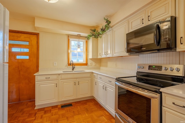 kitchen with light parquet floors, sink, a notable chandelier, hanging light fixtures, and stainless steel electric range