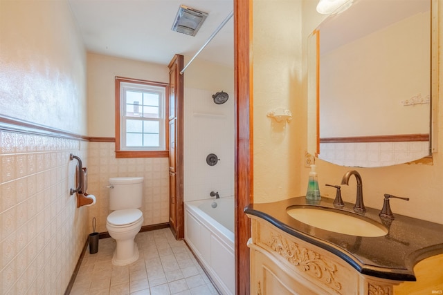 full bathroom with vanity, bathtub / shower combination, tile patterned floors, toilet, and tile walls