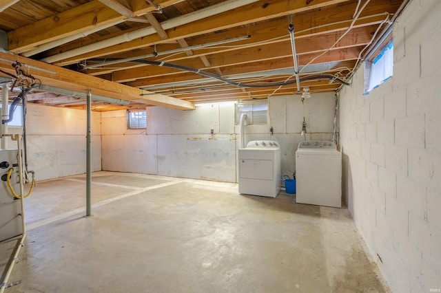 basement featuring washing machine and clothes dryer and plenty of natural light