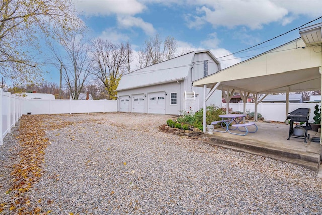 view of yard with a carport and a garage