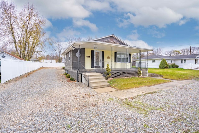 view of front of house with a porch and a front lawn