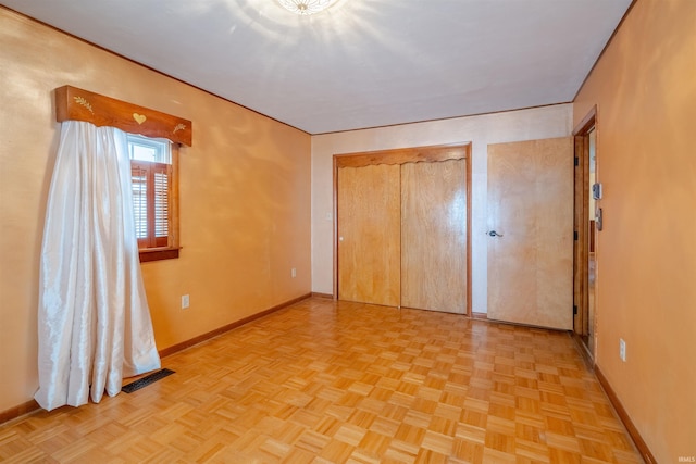 unfurnished bedroom featuring light parquet flooring