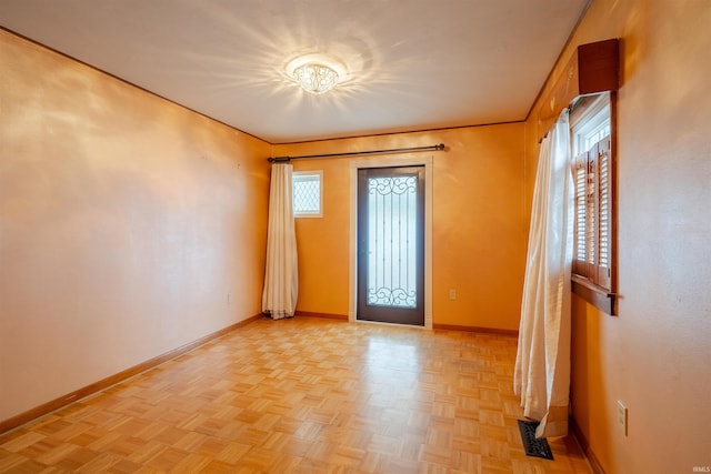 foyer entrance featuring plenty of natural light and light parquet flooring